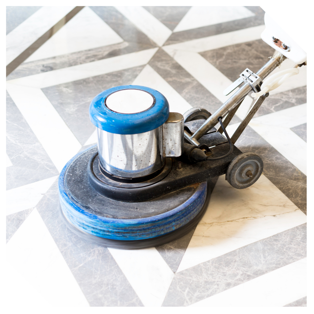 Close-up of a floor polishing machine with a blue pad meticulously gliding over the marble surface, enhancing its natural sheen.